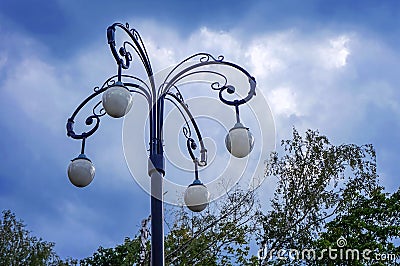 Street lamp with four white teardrop-shaped plafonds Stock Photo