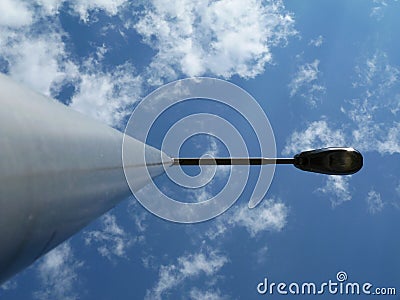 Street lamp pole and light fixture in diminishing perspective Stock Photo