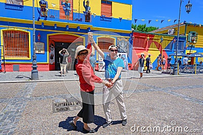 La Boca, Buenos Aires, Asian tourists dancing tango in front of colorful painted houses. Editorial Stock Photo