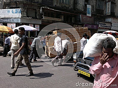 Street life in Mumbai India - men pushing cart loaded with boxes Editorial Stock Photo