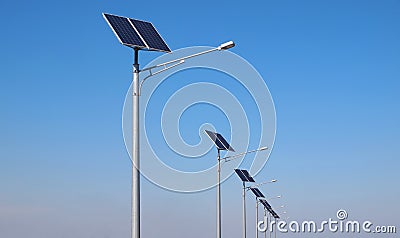 Street lighting pole with photovoltaic panel and LED lamp lights Stock Photo