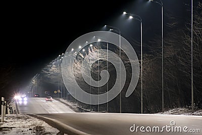 Street lighting, supports for ceilings with led lamps. concept of modernization and maintenance of lamps, place for text, night. Stock Photo