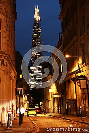 Street of London at night. The Shard of Glass skyscraper built in Neo futurism architectural style. Editorial Stock Photo