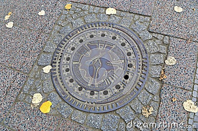 Street manhole cover on the paving stones in Berlin, Germany Editorial Stock Photo