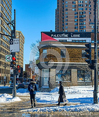 A street in Montreal in winter with "Palestine Libre" graffiti on a wall Editorial Stock Photo