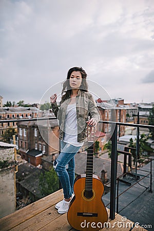 Street music. Young girl with acoustic guitar Stock Photo