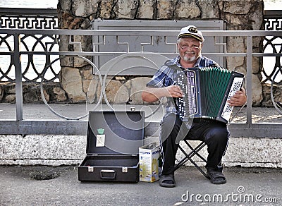 Street musician - harmonist Editorial Stock Photo