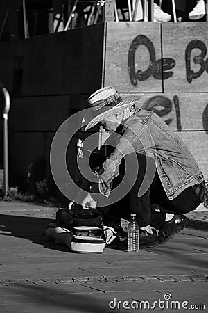 Street musician in a hat unpacking his guitar in Duesseldorf, Germany Editorial Stock Photo