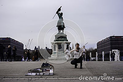 Street musician performing in front of Archduke Karl statue at Heldenplatz square Editorial Stock Photo