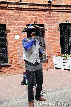 Street musician performs on the sidewalk Editorial Stock Photo