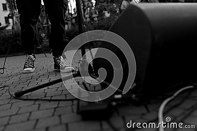 Street Musician Perspective: A Glimpse of Performance Life in Monochrome Stock Photo