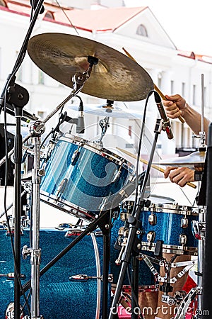 Street musician playing drums with drumsticks in his hands Stock Photo