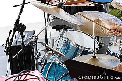 Street musician playing drums with drumsticks in his hands Stock Photo