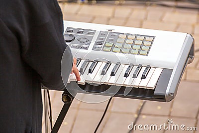 A street musician plays a keyboard and entertains the townspeople Stock Photo