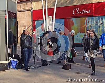 Street musicians or entertainers playing trumpets. Editorial Stock Photo