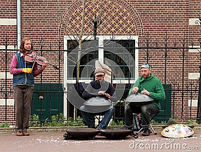 Street musicians with hang drums and violin performing in Amsterdam Editorial Stock Photo