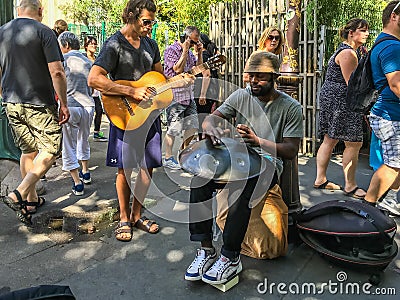 Street musicians play steel hand drum and guitar in Paris, France Editorial Stock Photo
