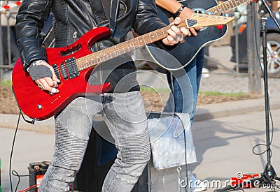 Street musicians playing on guitars. Stock Photo