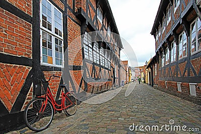 Street with old houses and vintage bicycle, royal town Ribe, Denmark Stock Photo