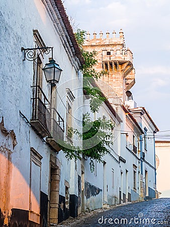 Street in the Old Town of Estremoz, Portugal. Three Crowns tower Stock Photo