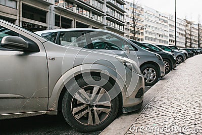 Street parking with cars in Lisbon, Portugal. Cars parked on street. Stock Photo