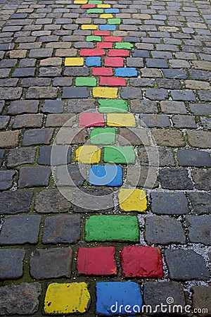 Street pavement with multi-colored painted stone blocks, close-up Stock Photo