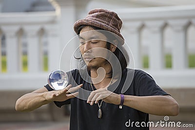 Street performer juggling glass bowl in front of passers-by on the street Khao San Road . Bangkok, Thailand Editorial Stock Photo