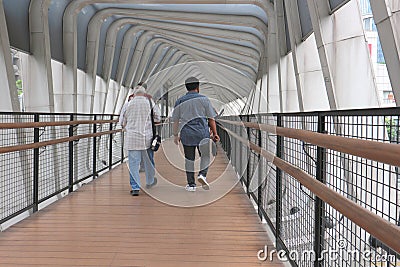 people cross the road via crossing bridge Editorial Stock Photo