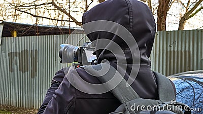 Street photographer shoots from monopod Editorial Stock Photo