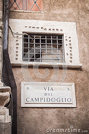 Street plaque Via Del Campidoglio at the foot of the statue of Romulus and Remus in Rome Stock Photo