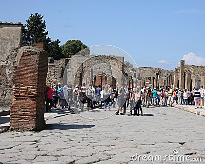 Street at Pompeii ruins in Italy with tourists. Editorial Stock Photo