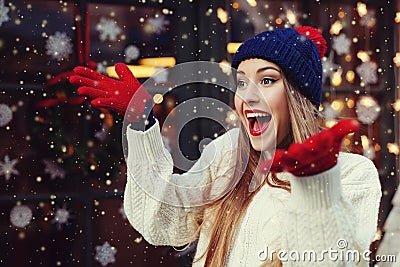 Street portrait of young beautiful woman acting thrilled, wearing stylish knitted clothes. Model expressing joy Stock Photo