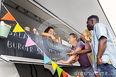 Customers or friends and saleswoman at food truck Stock Photo