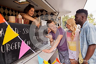 Seller showing menu to customers at food truck Stock Photo