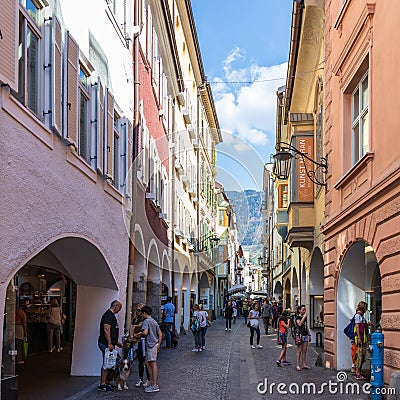 Street scenario of Laubengasse in the main District of Meran with many pedestrians. Merano. Province Bolzano, South Tyrol, Italy. Editorial Stock Photo