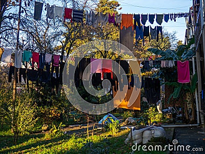 Clothes are dried on a line. Colorful houses. Urban environment. Beautiful sunny day in the city. Yard in Batumi. Aesthetics of Stock Photo