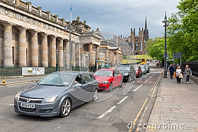 Street scene Edinburgh near Royal Scottish Academy with cars and pedestrians Editorial Stock Photo