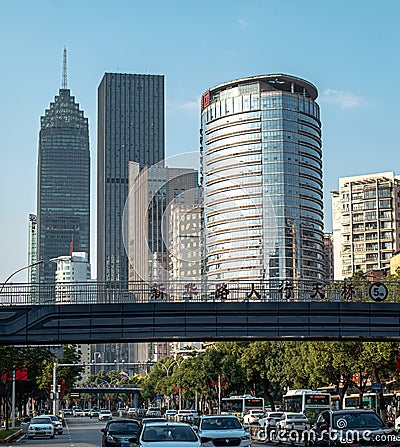 cars driving through a street under a bridge on the other side of the road Editorial Stock Photo