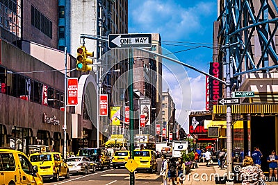 Street scenery at Broadway in Manhattan, NYC. Picture with traffic and cabs and the famous theater, musical ads and billdboards. Editorial Stock Photo