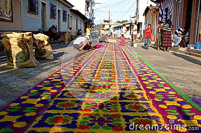 Street screen of locals producing alfombra, sawdust carpets with colorful designs for Semana Santa, Easter on the streets of Lake Editorial Stock Photo