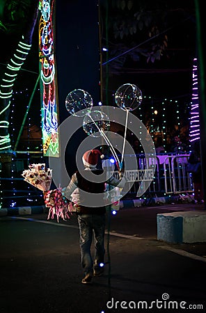 A street seller sells his product at the night of festival in Kolkata Editorial Stock Photo