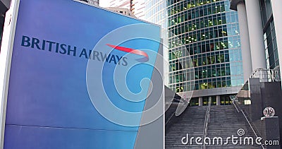 Street signage board with British Airways logo. Modern office center skyscraper and stairs background. Editorial 3D Editorial Stock Photo