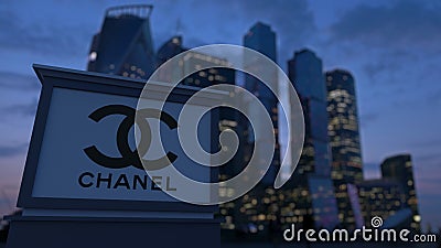 Street signage board with Chanel logo in the evening. Blurred business district skyscrapers background. Editorial 3 Editorial Stock Photo