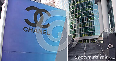 Street signage board with Chanel logo. Modern office center skyscraper and stairs background. Editorial 3D rendering Editorial Stock Photo