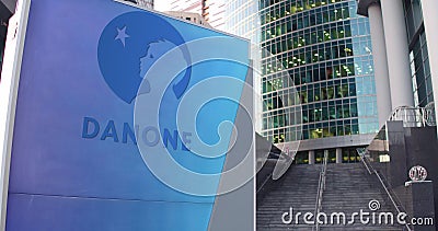 Street signage board with Danone logo. Modern office center skyscraper and stairs background. Editorial 3D rendering Editorial Stock Photo