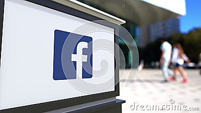 Street signage board with Facebook logo. Blurred office center and walking people background. Editorial 3D rendering Editorial Stock Photo