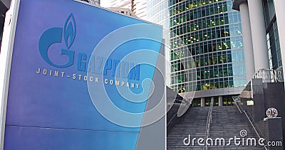 Street signage board with Gazprom logo. Modern office center skyscraper and stairs background. Editorial 3D rendering Editorial Stock Photo