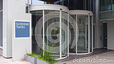 Street signage board with The Goldman Sachs Group, Inc. logo. Modern office building. Editorial 3D rendering Editorial Stock Photo