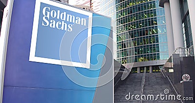 Street signage board with The Goldman Sachs Group, Inc. logo. Modern office center skyscraper and stairs background Editorial Stock Photo