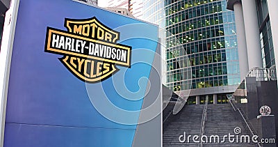 Street signage board with Harley-Davidson, Inc. logo. Modern office center skyscraper and stairs background. Editorial Editorial Stock Photo